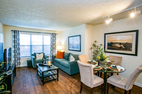 a living room and dining room with a couch and a table